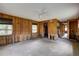 Living room featuring wood paneling, offering access to other rooms at 5290 Cyril Dr, Dade City, FL 33523