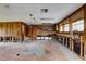 Spacious living room with wood paneled wall and kitchen area at 5290 Cyril Dr, Dade City, FL 33523