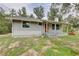 Single-story house showing side and front of house with lots of windows, porch, and chimney at 5290 Cyril Dr, Dade City, FL 33523