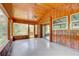 Enclosed sunroom with wood paneling, large windows, and exterior access at 5290 Cyril Dr, Dade City, FL 33523