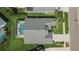Aerial view of the property showcasing the screened pool, well-maintained lawn and mature landscaping at 5303 Cottonwood Tree Cir, Valrico, FL 33596