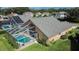 Aerial view of a home highlighting the backyard pool, screened enclosure, solar panels and manicured lawn at 5303 Cottonwood Tree Cir, Valrico, FL 33596