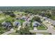 Aerial view showcases the home's location in a quiet neighborhood near a golf course with mature landscaping at 5303 Cottonwood Tree Cir, Valrico, FL 33596