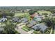 Aerial view shows a single Gathering home with a well-maintained lawn and landscaping in a residential neighborhood at 5303 Cottonwood Tree Cir, Valrico, FL 33596