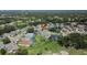 Aerial view of the property in a well-maintained community featuring lush landscaping and mature trees throughout at 5303 Cottonwood Tree Cir, Valrico, FL 33596
