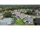 Aerial view of the house in a neighborhood with mature trees and lush landscaping at 5303 Cottonwood Tree Cir, Valrico, FL 33596