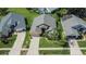 Aerial view of the home featuring a two-car garage, and lush landscaping at 5303 Cottonwood Tree Cir, Valrico, FL 33596