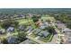 A serene aerial view reveals a home in a lush, well-kept neighborhood near a golf course and mature trees at 5303 Cottonwood Tree Cir, Valrico, FL 33596