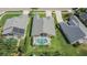 Aerial view of the home featuring a screened-in pool, well-maintained lawn, and mature trees at 5303 Cottonwood Tree Cir, Valrico, FL 33596