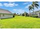 Expansive backyard featuring lush green grass and mature trees in a serene community setting at 5303 Cottonwood Tree Cir, Valrico, FL 33596