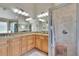 A modern bathroom featuring dual sinks, granite countertops, a tiled shower, and a separate soaking tub at 5303 Cottonwood Tree Cir, Valrico, FL 33596
