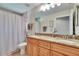 Bathroom with double vanity, granite countertops, and framed mirrors at 5303 Cottonwood Tree Cir, Valrico, FL 33596