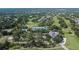 Aerial view of a community with lush golf course, pool, tennis courts and clubhouse at 5303 Cottonwood Tree Cir, Valrico, FL 33596
