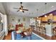Open dining area featuring a glass table, hardwood floors, and an adjacent kitchen with counter seating at 5303 Cottonwood Tree Cir, Valrico, FL 33596