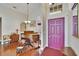 Inviting entryway with a grand piano, chandelier, and a striking purple front door at 5303 Cottonwood Tree Cir, Valrico, FL 33596