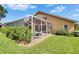 Home exterior showcasing a screened-in pool area, patio, and lush landscaping in a well-kept backyard at 5303 Cottonwood Tree Cir, Valrico, FL 33596
