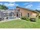 Exterior of this home with a screened-in pool, patio seating, and a vast lawn at 5303 Cottonwood Tree Cir, Valrico, FL 33596