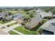 Aerial shot of a single-Gathering home with a well-manicured lawn, a two car garage, and mature palm trees at 5303 Cottonwood Tree Cir, Valrico, FL 33596