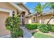 Inviting home entrance features a cozy seating area and vibrant landscaping, creating a warm and welcoming ambiance at 5303 Cottonwood Tree Cir, Valrico, FL 33596