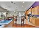 Kitchen with stainless steel appliances, wooden cabinets, granite countertops, and seating at the counter at 5303 Cottonwood Tree Cir, Valrico, FL 33596