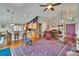 Open-concept living area featuring wood floors, a grand piano, and a vibrant purple accent wall at 5303 Cottonwood Tree Cir, Valrico, FL 33596