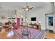 Bright living room with vaulted ceilings, hardwood floors, and a plush area rug at 5303 Cottonwood Tree Cir, Valrico, FL 33596