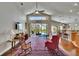 Bright living room with soaring ceilings, hardwood floors, and views of the screened-in pool area at 5303 Cottonwood Tree Cir, Valrico, FL 33596