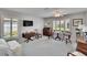 Bright main bedroom with large windows, ceiling fan and carpeted floors offering a calming space at 5303 Cottonwood Tree Cir, Valrico, FL 33596