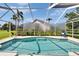 Screened pool with lounge chairs, lush landscaping, and a privacy screen for enjoying outdoor relaxation at 5303 Cottonwood Tree Cir, Valrico, FL 33596