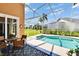 Screened-in pool area with patio furniture, landscaping, and clear blue skies offering the perfect outdoor living space at 5303 Cottonwood Tree Cir, Valrico, FL 33596