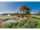 Scenic community entrance with a rock waterfall, lush landscaping, and a serene fountain at 5303 Cottonwood Tree Cir, Valrico, FL 33596