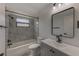 Bathroom features a modern vanity, a new tub with tiled walls, and attractive fixtures at 5435 20Th N Ave, St Petersburg, FL 33710