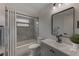 Bathroom features a modern vanity, a new tub with tiled walls, and attractive fixtures at 5435 20Th N Ave, St Petersburg, FL 33710