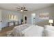 Bedroom featuring hardwood floors, a ceiling fan, and ensuite bathroom at 5435 20Th N Ave, St Petersburg, FL 33710