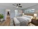 Bright bedroom with hardwood floors, ceiling fan, and ensuite bathroom at 5435 20Th N Ave, St Petersburg, FL 33710
