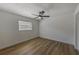 Bright, clean bedroom featuring wood-look flooring, a ceiling fan, and natural light at 5435 20Th N Ave, St Petersburg, FL 33710