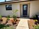 Inviting entryway showcasing a stylish blue front door, lush landscaping, and a welcoming walkway at 5435 20Th N Ave, St Petersburg, FL 33710