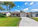 Well-maintained single-Gathering home with a tidy front yard and a driveway leading to the garage at 5435 20Th N Ave, St Petersburg, FL 33710