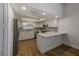 Bright kitchen showcasing white cabinets, stainless steel appliances, and a counter with bar stool seating at 5435 20Th N Ave, St Petersburg, FL 33710