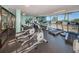 Modern gym with cardio equipment and floor to ceiling windows overlooking the water at 6009 Sea Ranch Dr # 306, Hudson, FL 34667