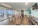 Well-equipped gym with weights and machines and wall to wall windows offering plenty of natural light at 6009 Sea Ranch Dr # 306, Hudson, FL 34667