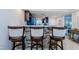 Open concept kitchen showcasing a breakfast bar with seating and modern finishes at 6009 Sea Ranch Dr # 306, Hudson, FL 34667