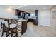 Bright kitchen with a breakfast bar and a view into the kitchen with dark cabinets at 6009 Sea Ranch Dr # 306, Hudson, FL 34667
