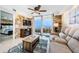 Inviting living room with a cozy fireplace and balcony access featuring ocean views at 6009 Sea Ranch Dr # 306, Hudson, FL 34667