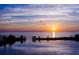 Aerial sunset view over calm waters and tree-lined land, reflecting a serene vista at 6009 Sea Ranch Dr # 306, Hudson, FL 34667