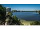 Scenic water view overlooking tranquil waters, a nearby building, and lush trees at 6009 Sea Ranch Dr # 306, Hudson, FL 34667