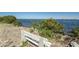 Relax on the waterfront bench surrounded by natural landscaping, offering a serene ocean view at 6009 Sea Ranch Dr # 306, Hudson, FL 34667