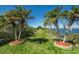 Landscaped yard with palm trees and manicured lawns near the waterfront, creating a tropical feel at 6009 Sea Ranch Dr # 306, Hudson, FL 34667