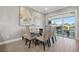 Dining area with modern glass-top table and access to the balcony overlooking a canal at 6049 Moorings S Dr, St Petersburg, FL 33712