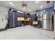 Organized garage featuring custom cabinets, work bench, stainless refrigerator, and epoxy floors at 6049 Moorings S Dr, St Petersburg, FL 33712